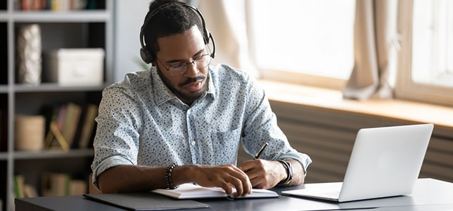 student working with laptop at home